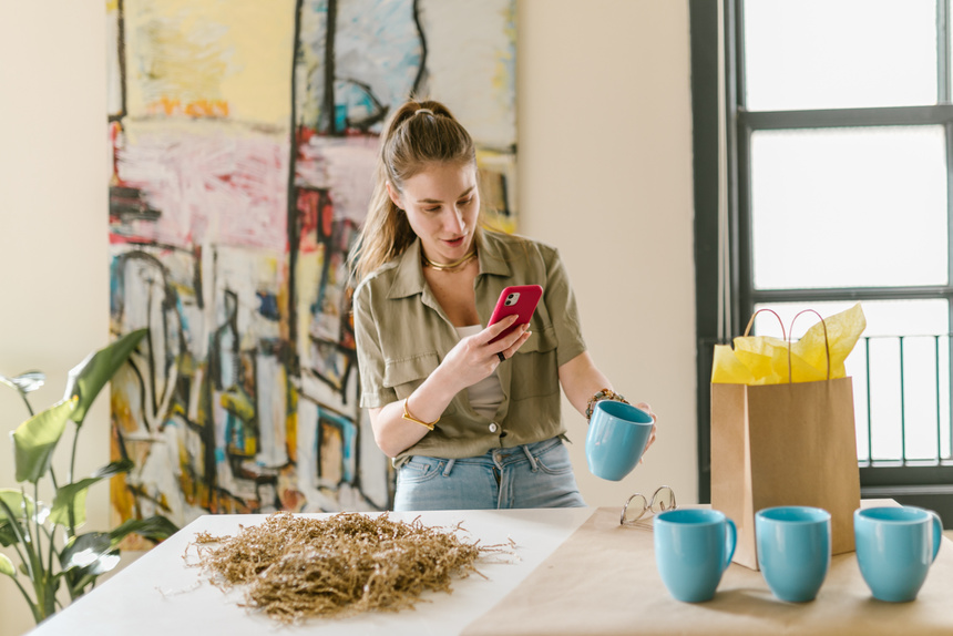 Girl in Brown Jacket Holding Blue Ceramic Mug